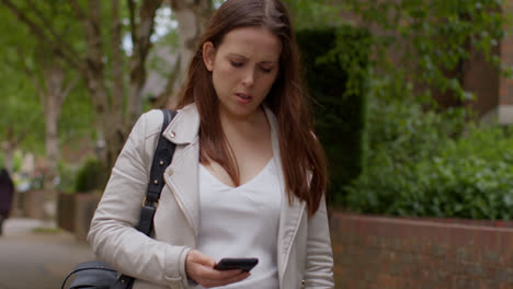 Stressed-And-Anxious-Woman-Outdoors-With-Financial-Worries-About-Cost-Of-Living-Crisis-Checking-Money-Purse-After-Looking-At-Mobile-Phone-On-City-Street